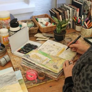 Artist creating mxed media art